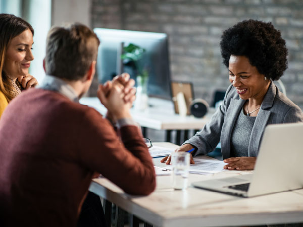 Two adults meeting with a bank representative