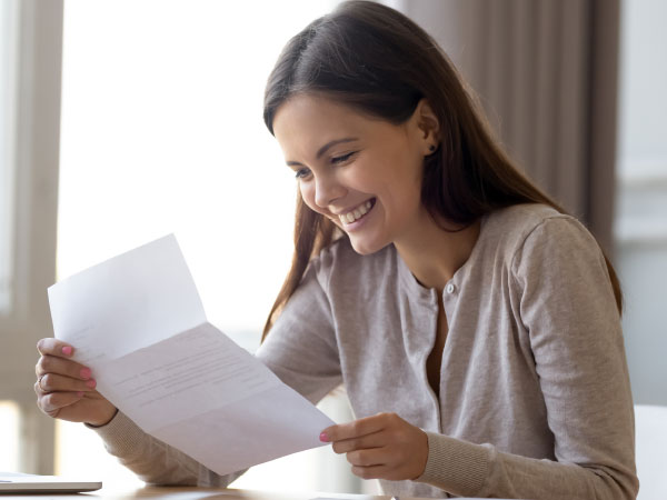 Young woman reading her bank statement