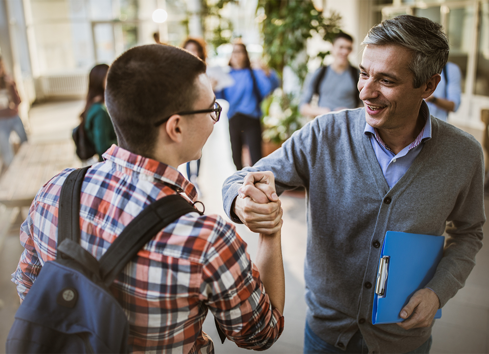 Teacher and a student shaking hands