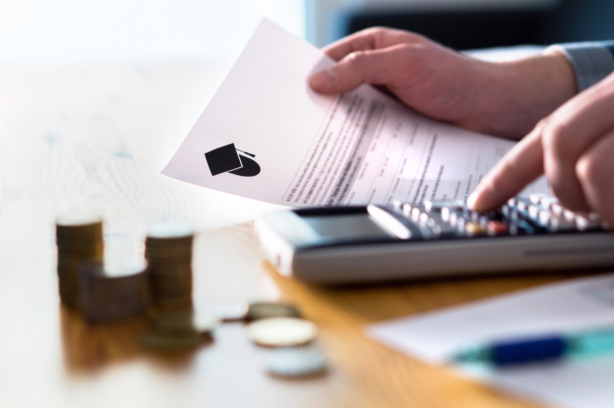 Man counting college savings fund, tuition fee or student loan with calculator.