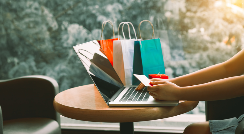 Woman using credit card while shopping online.